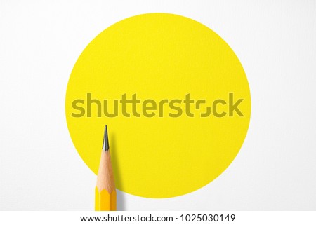 Minimalist template with copy space by top view close up macro photo of wooden yellow pencil isolated on white texture paper and combine with yellow circle. Flash light made smooth shadow from pencil. Royalty-Free Stock Photo #1025030149