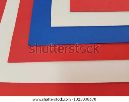 abstract with sheets of plastic in colours blue, red and white, textured background