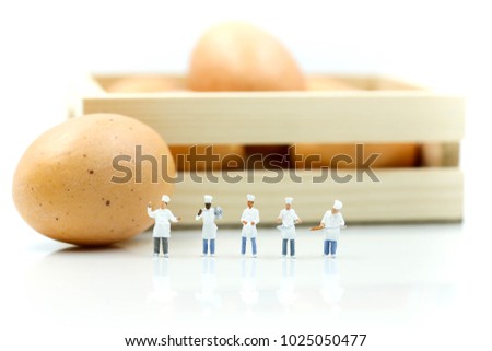 Miniature people : Chef during cooking and working with eggs.