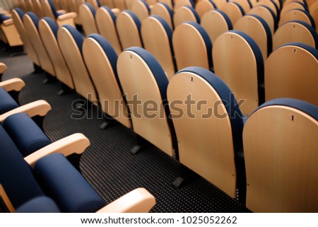 Seats are arranged in row in hall of opera, theater, cinema. Comfortable and soft chairs.