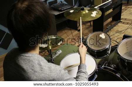 The drummer playing the drum set