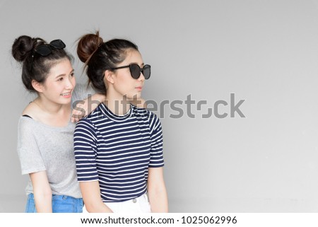 Pretty asian tourist duo girl posing isolated on grey background.