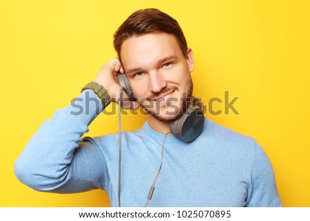 lifestyle and people concept: young man listening to music with 