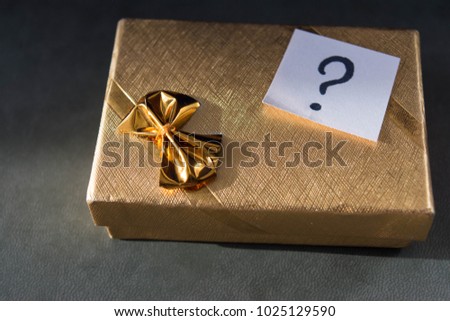 Golden box with question inside