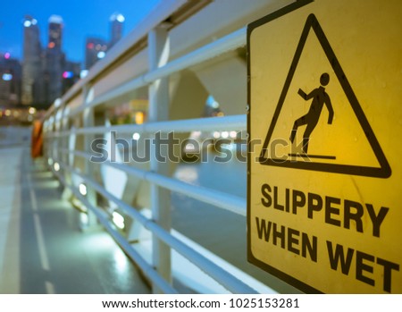 man slip on wet floor icon, yellow signage for people to walk carefully on wet floor at bridge area after rain