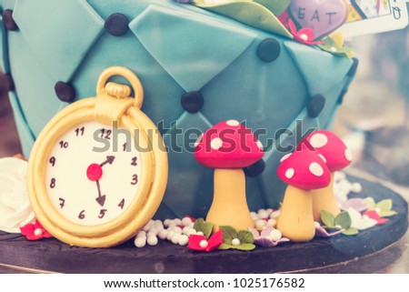 Blurred for Background.Gold watch and red mushroom molded from clay,Vintage Style.