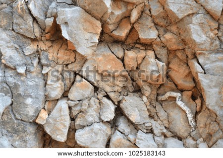 Surface of a grey and reddish rock suitable for a background