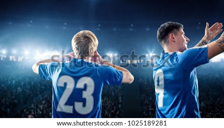 Happy soccer player celebrate a victory on a professional football stadium