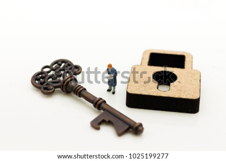 Miniature people: Businessmen stand with master key and reading newspaper. Image use for key man, the key to success, business concept.