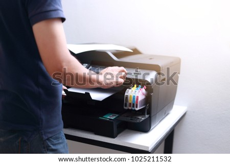 Bussiness man  hand press button on panel of printer