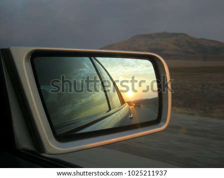 sunset in the car's mirror