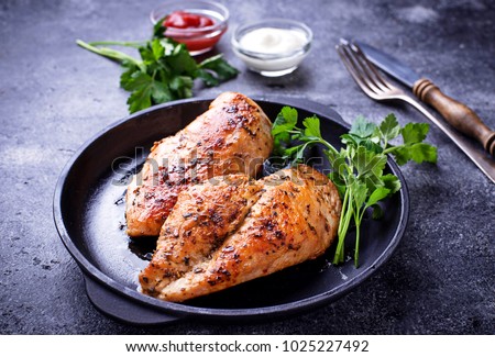 Grilled chicken breast or fillet on iron pan. Top view Royalty-Free Stock Photo #1025227492