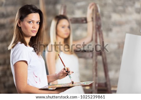 Portrait of young beautiful painter woman