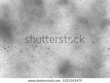 Subtle grain texture. Abstract black and white gritty grunge background. Dark paint spray particles on paper
