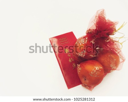 Happy Chinese New Year Red Envelope and Bag of Oranges on White Background 