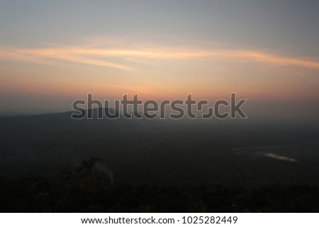 Beautiful morning with sunrise above mountain ranges at Pha ( cliff)moo-e-daeng,kao prawihan  national park, Thailand