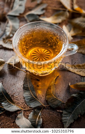 Neem tea with leaves on a wooden surface is Immune Boosting - Neem leaf tea is a good immune boosting agent that works well to keep away cardiovascular disease, strokes, and cancer.