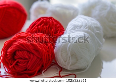 Close-up of red and white strains of yarn for martenitsi symbolizing health. Baba Marta Day. UNESCO List Cultural Heritage Humanity.