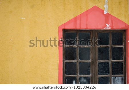 Background: window of cabin, high mountain cottage, colorful, red, yellow, during snowfall, ice lollies, old wood, architecture, Vigezzo Valley, Piedmont, Italy