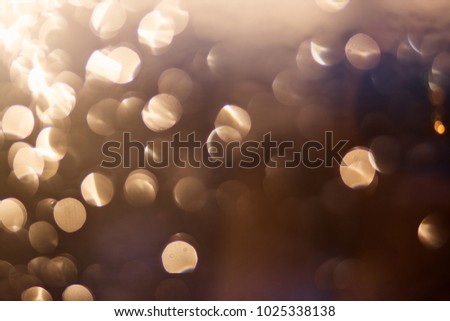 Defocused of yellow and deep orange LED light on black background. Bokeh photo of LED light. Chrome and xanthous. Sunny and darkness Bokeh. Light and dark blurred contrasted photo.