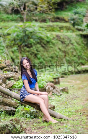 Thailand Girl dressed in summer dress sit down path in Bamboo forest