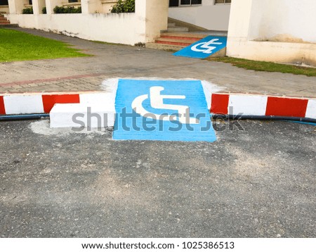 Disabled symbol pathway for wheelchair ramp in place background texture.