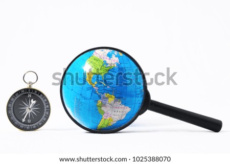 Orientation Concept Earth,Magnify Glass and Compass on a White Background