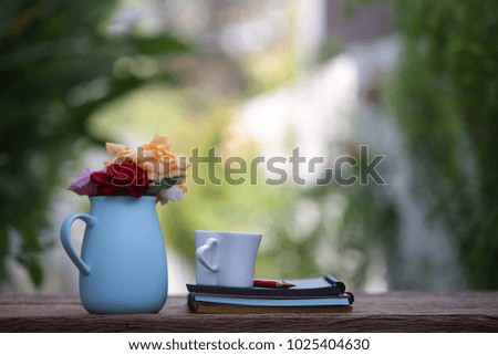 Colorful Roses in blue pot with notebook 