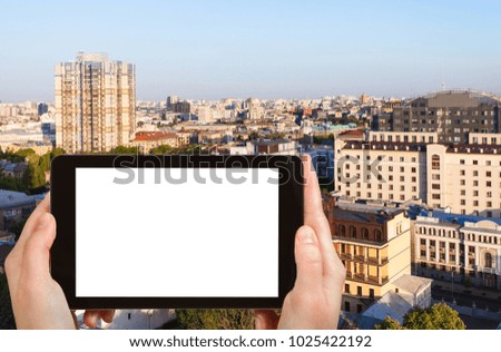 travel concept - tourist photographs Kiev city in Ukraine in spring sunrise on tablet with cut out screen for advertising logo