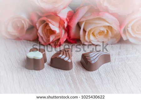 sweets and roses on wooden table for gift 