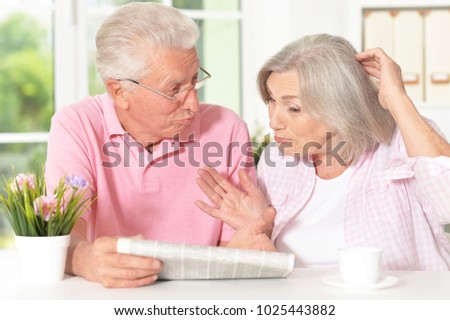 senior couple with newspaper
