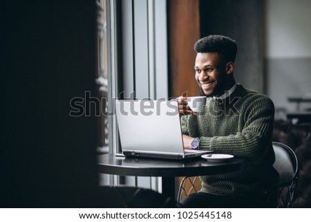 African american man working on laptop in a cafe