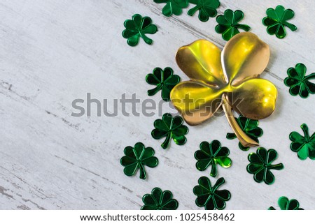 St Patrick's day with large gold four leaf clover and smaller green four leaf clovers
