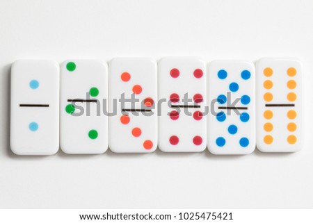 Domino game pieces shot up against a white background