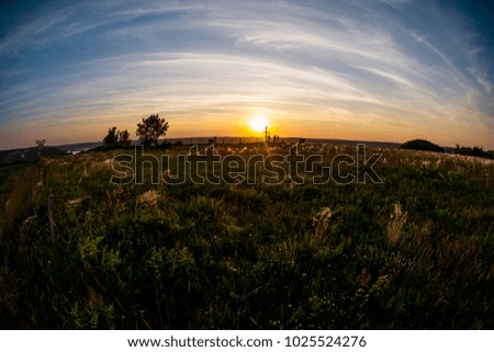 Beautiful sunset with silhouette cross and trees and people in bakota