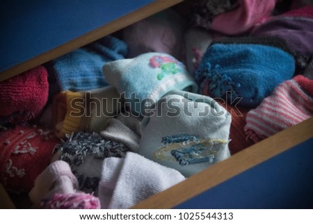 A blue drawer full of children's socks