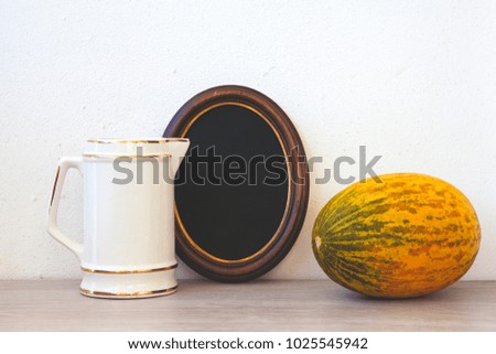 white jug, frame for photography and melon. mock up. Empty picture in a frame shabby chic, vintage style. Copy the image of the insert.