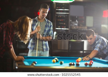 Young friends at a billiard club having a good time