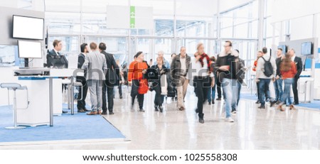blurred people at a trade fair hall Royalty-Free Stock Photo #1025558308