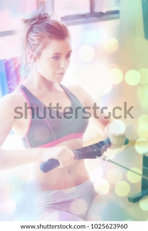 Abstract background against woman pulling on row machine