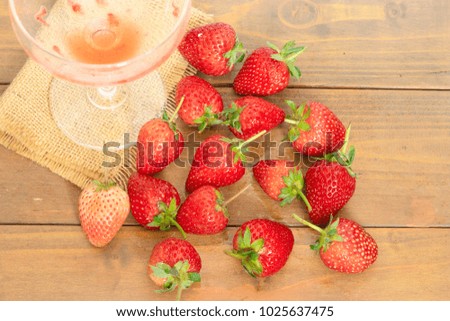 fresh strawberry on wooden table,Drinking strawberry juice is healthy. /selective focus