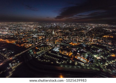 Night aerial view towards urban downtown buildings and streets in Los Angeles California.