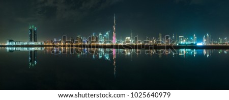 Panoramic picture for dubai city reflected on the water. 