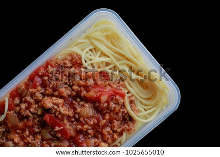 Spaghetti with plastic box, on black. Microwave Dinner