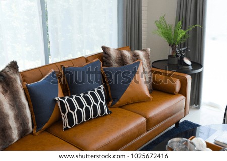 luxury cushion on brown leather sofa in modern living room.