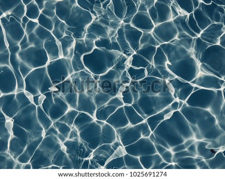 swimming pool rippled water detail background.