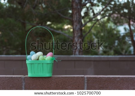 Basket full of Easter eggs framed left