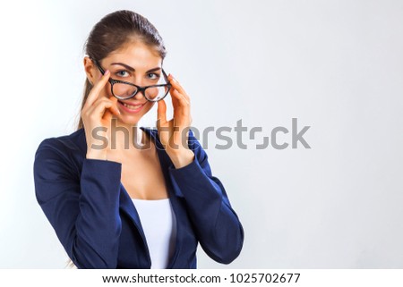 beautiful girl in blue suit and glasses, business lady on white background, office style