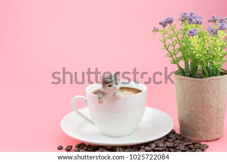 coffee cup with cofee beans and flower on pink background. 