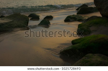 Rocks on the beach and the waves of the sea at Had saengchan beach in Rayong Province, Thailand.
